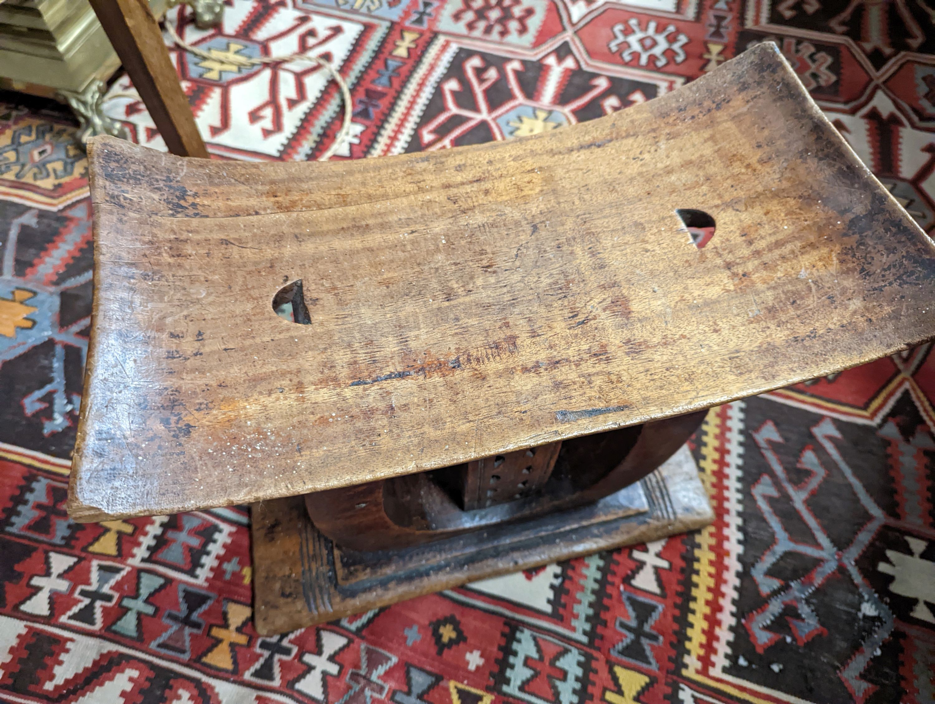 Two African carved hardwood stools, larger length 43cm, depth 19cm, height 37cm